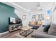 Bright living room with hardwood floors, a modern TV, and comfortable seating at 4419 N Quatar Ct, Aurora, CO 80019