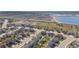 Wide aerial view of a new neighborhood development near open land and a lake at 5659 Viewpoint Ave, Firestone, CO 80504