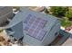 Aerial view of a well-maintained home with solar panels on the roof, surrounded by mature trees at 5659 Viewpoint Ave, Firestone, CO 80504