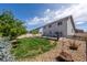 Expansive backyard featuring a privacy fence, mature trees, a well-maintained lawn, and a concrete patio at 5659 Viewpoint Ave, Firestone, CO 80504