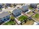 Aerial view of a home's backyard featuring a green lawn, patio area, playground, and white fence at 5659 Viewpoint Ave, Firestone, CO 80504