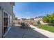 Back patio with outdoor seating and a manicured lawn, perfect for entertaining and relaxing in the sun at 5659 Viewpoint Ave, Firestone, CO 80504