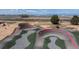 View of a pump track with berms, rollers and winding features, framed by a landscape view including trees and distant mountains at 5659 Viewpoint Ave, Firestone, CO 80504