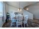 Cozy dining room features a round table and chairs, large window, and contemporary light fixture at 5659 Viewpoint Ave, Firestone, CO 80504