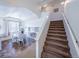 Bright entryway featuring a staircase, high ceilings, and an adjacent dining area with a round table at 5659 Viewpoint Ave, Firestone, CO 80504