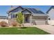 Charming two-story home with solar panels, landscaped yard, stone accents, and an attached two-car garage at 5659 Viewpoint Ave, Firestone, CO 80504