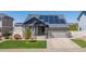 Charming home featuring a two-car garage, solar panels, and a well-maintained lawn at 5659 Viewpoint Ave, Firestone, CO 80504