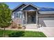 Charming home with stone accents, a well-manicured lawn, and solar panels, offering both curb appeal and energy efficiency at 5659 Viewpoint Ave, Firestone, CO 80504
