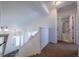 Bright hallway with stairs going up to the second floor and doorway leading into bathroom at 5659 Viewpoint Ave, Firestone, CO 80504