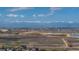 Far landscape view featuring mountains and open land, along with commercial and residential areas, including lakes at 5659 Viewpoint Ave, Firestone, CO 80504