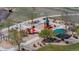 Overhead view of a colorful playground with slides, swings, and climbing structures amid landscaped greenery at 5659 Viewpoint Ave, Firestone, CO 80504
