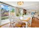 Bright dining area with backyard views, a decorative chandelier, and access to the kitchen at 8179 S Corona Way, Centennial, CO 80122