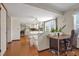 Open-concept dining area with hardwood floors, great natural light, and breakfast bar at 8179 S Corona Way, Centennial, CO 80122