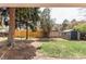 Spacious backyard featuring mature trees, a storage shed, and well-maintained grass at 8370 E Princeton Ave, Denver, CO 80237