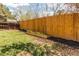Fenced backyard with green grass and flower beds at 8370 E Princeton Ave, Denver, CO 80237