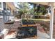 Landscaped backyard with flower beds, mature trees, and a well-maintained lawn at 8370 E Princeton Ave, Denver, CO 80237