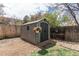 Backyard shed surrounded by wooden fence and blooming flowers at 8370 E Princeton Ave, Denver, CO 80237