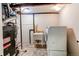Basement laundry and utility area with a washing machine, dryer, water heater, and sink at 8370 E Princeton Ave, Denver, CO 80237