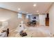 Finished basement featuring a play area with play tent, table and chairs, and a comfortable lounge space at 8370 E Princeton Ave, Denver, CO 80237