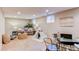 Finished basement offers a comfortable seating area, play tent, and ample natural light from the windows at 8370 E Princeton Ave, Denver, CO 80237