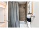 Bathroom showcasing a tiled shower, modern fixtures, and soft lighting at 8370 E Princeton Ave, Denver, CO 80237