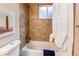 Bathroom tub/shower featuring a window and decorative shower curtain at 8370 E Princeton Ave, Denver, CO 80237