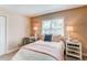 Charming bedroom with a full size bed, neutral paint, and a light-filled window at 8370 E Princeton Ave, Denver, CO 80237