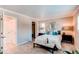 Inviting bedroom featuring plush carpet, neutral colors, and an en-suite bathroom at 8370 E Princeton Ave, Denver, CO 80237