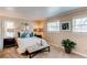 Comfortable bedroom with natural light, neutral paint colors, and plush carpeting at 8370 E Princeton Ave, Denver, CO 80237