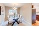 Elegant dining room featuring a glass table, modern chandelier, and seating for six at 8370 E Princeton Ave, Denver, CO 80237