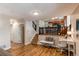 Well-lit entryway with hardwood floors, staircase, and an adjacent office space or breakfast nook at 8370 E Princeton Ave, Denver, CO 80237