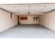 Spacious, empty two-car garage features painted walls and floors at 8370 E Princeton Ave, Denver, CO 80237