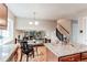 Open-concept kitchen and living area with granite counters and hardwood floors, ideal for entertaining at 8370 E Princeton Ave, Denver, CO 80237