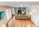 Bright and spacious living room with a fireplace, built-in bookshelves, and hardwood floors at 8370 E Princeton Ave, Denver, CO 80237
