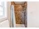 This tiled shower offers a sleek design with a shower head and a built-in storage rack at 8370 E Princeton Ave, Denver, CO 80237