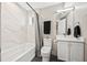 Bright bathroom with a tub, shower, modern fixtures, and a vanity with storage at 1302 N Stuart St, Denver, CO 80204