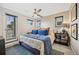 Bright bedroom with neutral walls, a ceiling fan, a large window, and a comfortable bed at 1302 N Stuart St, Denver, CO 80204
