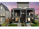 Modern home featuring a stylish brick facade, balconies, and well-maintained front yard with a privacy fence at 1302 N Stuart St, Denver, CO 80204