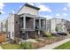 Modern home featuring a brick facade, balconies, and fenced front yard with patio furniture at 1302 N Stuart St, Denver, CO 80204