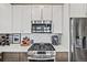 Close up of modern kitchen with stainless steel appliances, white countertops and gray cabinets at 1302 N Stuart St, Denver, CO 80204