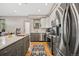 Modern kitchen featuring stainless steel appliances, an island with seating, and ample counter space at 1302 N Stuart St, Denver, CO 80204