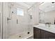 Modern shower with glass door and rainfall shower head, complemented by a sleek vanity at 1302 N Stuart St, Denver, CO 80204