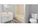 Bathroom featuring a vanity, tub with tile surround, and vinyl flooring for an easy-to-maintain space at 10731 W 63Rd Ave # A, Arvada, CO 80004
