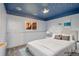 Staged bedroom with galaxy ceiling design, carpet, and a window view to the backyard at 10731 W 63Rd Ave # A, Arvada, CO 80004