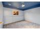 Bedroom featuring ceiling design, carpet, and window to backyard at 10731 W 63Rd Ave # A, Arvada, CO 80004