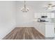 Open concept living and dining room featuring chandelier lighting and eat-in kitchen at 10731 W 63Rd Ave # A, Arvada, CO 80004