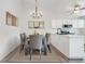 Dining area off kitchen featuring chandelier lighting and room for six at the table at 10731 W 63Rd Ave # A, Arvada, CO 80004