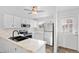 Updated kitchen with white cabinets, stainless steel appliances, and marble countertops at 10731 W 63Rd Ave # A, Arvada, CO 80004