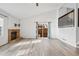 Bright living room with fireplace, vaulted ceiling, sliding glass door to patio, and stairs at 10731 W 63Rd Ave # A, Arvada, CO 80004