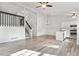 Spacious living room with hardwood floors, lots of natural light, stairs to 2nd floor, and kitchen at 10731 W 63Rd Ave # A, Arvada, CO 80004